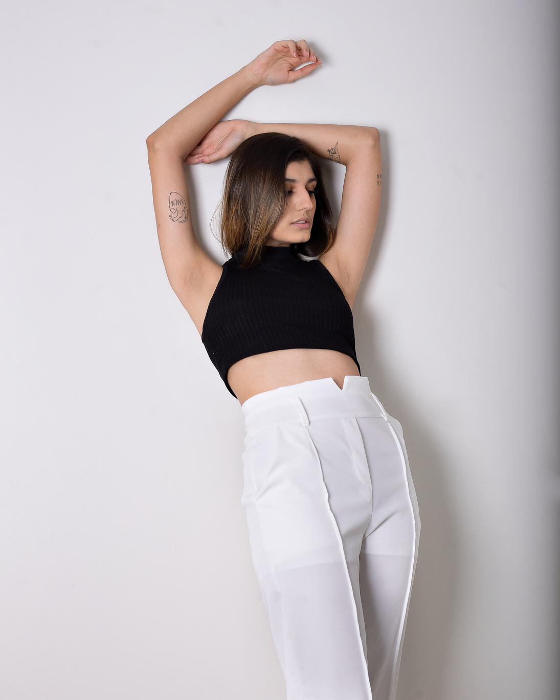 Woman in Black Tank Top and White Pants